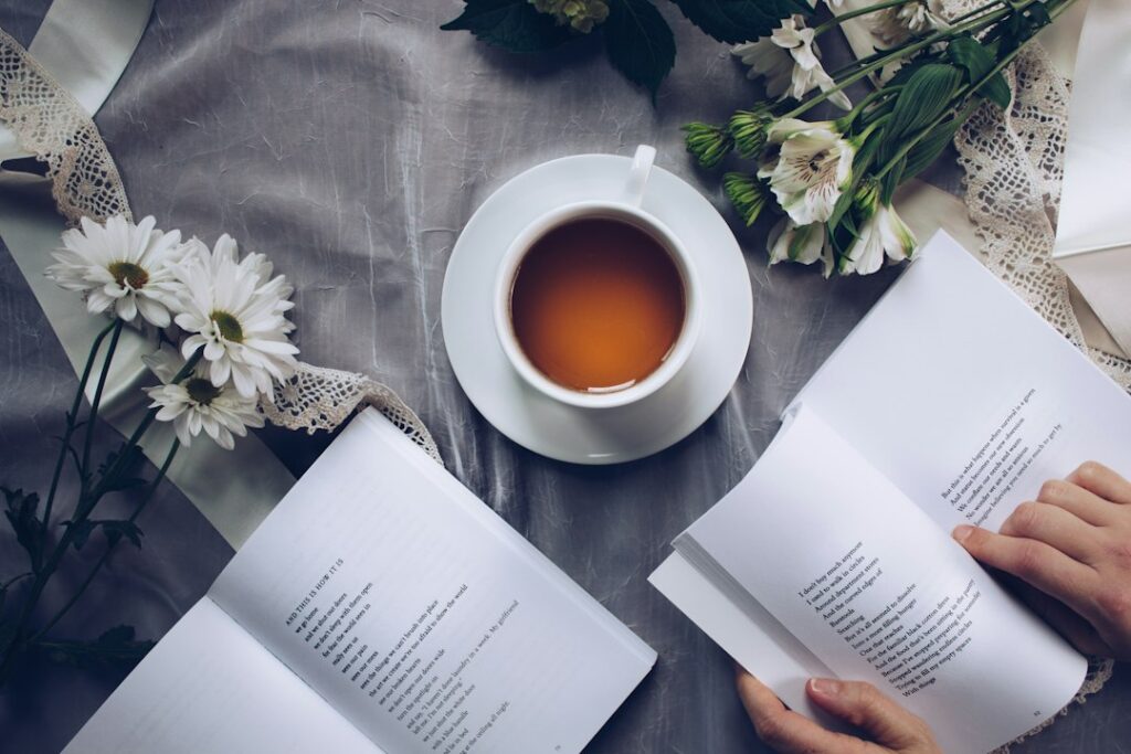 An open book with tea and flowers.